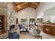 Bright living room with vaulted ceilings, stone fireplace, and views of the pool area at 1905 N Calle Maderas --, Mesa, AZ 85213