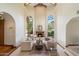 Elegant living room with a fireplace, beamed ceilings, and large arched windows at 1905 N Calle Maderas --, Mesa, AZ 85213