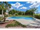 Refreshing pool with lush landscaping, palm trees, green grass and a fountain at 1905 N Calle Maderas --, Mesa, AZ 85213