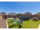 Backyard featuring an above ground pool, artificial grass, and ample seating area, perfect for outdoor relaxation at 19771 W Woodlands Ave, Buckeye, AZ 85326