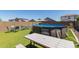 Outdoor backyard with above ground pool, dining set, and artificial turf at 19771 W Woodlands Ave, Buckeye, AZ 85326