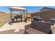 Backyard patio with grill, gazebo, outdoor kitchen, and comfortable wicker chairs at 19771 W Woodlands Ave, Buckeye, AZ 85326