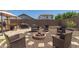 Backyard featuring gravel landscaping, a cozy fire pit, and an outdoor cooking area with a grill and covered gazebo at 19771 W Woodlands Ave, Buckeye, AZ 85326