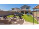 Landscaped backyard with a fire pit, seating, above-ground pool, and patio area for relaxing and entertaining at 19771 W Woodlands Ave, Buckeye, AZ 85326
