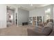 Cozy bonus room with a comfortable couch and shelving for storage and decor at 19771 W Woodlands Ave, Buckeye, AZ 85326