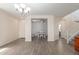 Bright dining area with natural light, hardwood flooring, and an adjacent stairway at 19771 W Woodlands Ave, Buckeye, AZ 85326