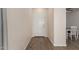 Entryway with hardwood floors leading to the front door and dining room at 19771 W Woodlands Ave, Buckeye, AZ 85326