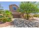 Charming two-story home featuring desert landscaping, a two-car garage, and a welcoming entrance at 19771 W Woodlands Ave, Buckeye, AZ 85326