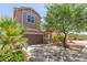 Two-story house showcasing landscaped front yard, a two car garage and covered front porch at 19771 W Woodlands Ave, Buckeye, AZ 85326