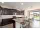 Modern kitchen with granite countertops, an island with seating, and stainless steel appliances at 19771 W Woodlands Ave, Buckeye, AZ 85326