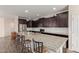 Spacious kitchen features a large island with seating, stainless steel appliances and granite countertops at 19771 W Woodlands Ave, Buckeye, AZ 85326