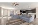 Open living space showcasing hardwood floors that connect the kitchen, dining area, and living room at 19771 W Woodlands Ave, Buckeye, AZ 85326
