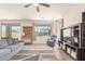 Cozy living room featuring a ceiling fan, recliner and comfortable sofa at 19771 W Woodlands Ave, Buckeye, AZ 85326