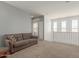 Spacious loft area with comfortable seating, natural light, and convenient access to the laundry room at 19771 W Woodlands Ave, Buckeye, AZ 85326