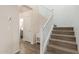 Inviting staircase featuring carpeted steps, and white banisters with hardwood floors on the landing at 19771 W Woodlands Ave, Buckeye, AZ 85326