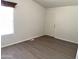 Neutral-toned bedroom with wood-style floors and a bright window at 2206 S Ellsworth Rd # 1736, Mesa, AZ 85209