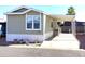 Inviting home featuring a covered carport and manicured flowerbeds at 2206 S Ellsworth Rd # 1736, Mesa, AZ 85209