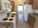 Cozy kitchen featuring white appliances, granite countertops, and wood cabinets at 2206 S Ellsworth Rd # 1736, Mesa, AZ 85209