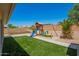 The backyard features an artificial lawn and a playground structure at 22610 W Mohave St, Buckeye, AZ 85326