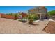 Backyard with a play structure, patio, desert landscaping, and privacy wall at 22610 W Mohave St, Buckeye, AZ 85326