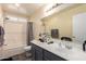 Bathroom featuring a shower-tub combo, a toilet, and vanity with ample counter space with a large mirror at 22610 W Mohave St, Buckeye, AZ 85326