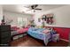 bedroom with two beds, a ceiling fan, built-in storage, and colorful decorations creates a fun space at 22610 W Mohave St, Buckeye, AZ 85326