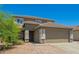 Inviting two-story home with a well-manicured yard and a classic brown color scheme at 22610 W Mohave St, Buckeye, AZ 85326