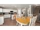 Bright kitchen features white cabinets, stainless steel appliances, and an eat-in dining area at 22610 W Mohave St, Buckeye, AZ 85326