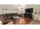 Spacious living room with hardwood floors, a ceiling fan, and ample seating at 22610 W Mohave St, Buckeye, AZ 85326