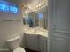A vanity with a large mirror, decorative lighting, and a tile floor offer a classic look at 2290 S Seminole Dr, Apache Junction, AZ 85119