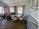 Open dining area with wood floors, neutral walls, and view of outdoor swimming pool at 2290 S Seminole Dr, Apache Junction, AZ 85119