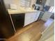 The kitchen features wood floors, white cabinetry, granite countertops, and black appliances at 2290 S Seminole Dr, Apache Junction, AZ 85119