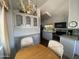 Eat-in kitchen features white cabinets, stainless appliances, and an eye-catching chandelier at 2290 S Seminole Dr, Apache Junction, AZ 85119