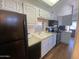 Well-equipped kitchen with white cabinets, sleek black appliances, and ample counter space at 2290 S Seminole Dr, Apache Junction, AZ 85119