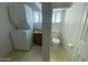 Functional laundry area with a stackable washer and dryer near the toilet for convenience at 2290 S Seminole Dr, Apache Junction, AZ 85119