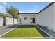 View of home exterior with a covered patio and artificial turf area in the backyard at 2402 N 15Th St, Phoenix, AZ 85006