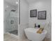 This bathroom features a soaking tub and a glass-enclosed shower with marble accents, and modern fixtures at 2402 N 15Th St, Phoenix, AZ 85006