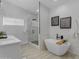 This bathroom has a soaking tub and a glass-enclosed shower with marble accents, and modern fixtures at 2402 N 15Th St, Phoenix, AZ 85006