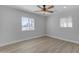 This bedroom features wood floors, a ceiling fan, a window, and neutral walls at 2402 N 15Th St, Phoenix, AZ 85006
