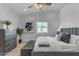 This bedroom features a ceiling fan, a window, stylish decor, and a gray upholstered bed frame and bench at 2402 N 15Th St, Phoenix, AZ 85006