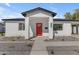 Close-up of the front of the home showcasing a red door, modern mailbox, and xeriscape landscaping at 2402 N 15Th St, Phoenix, AZ 85006