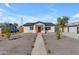 Charming single-story home with a red front door, xeriscape yard, and a walkway leading to the entrance at 2402 N 15Th St, Phoenix, AZ 85006