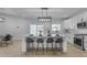 Modern kitchen with a large island, bar stools, pendant lighting, white cabinets, and stainless steel appliances at 2402 N 15Th St, Phoenix, AZ 85006