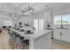 Bright, open kitchen features a large island with a waterfall countertop and modern lighting fixtures at 2402 N 15Th St, Phoenix, AZ 85006