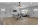 Spacious living room featuring wood floors, neutral walls, large windows, and contemporary furnishings at 2402 N 15Th St, Phoenix, AZ 85006
