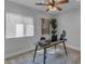 This home office includes a fan, desk, decor, and a window with bright natural light at 2402 N 15Th St, Phoenix, AZ 85006