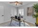 This well-lit home office has a desk, stylish decor, and a window at 2402 N 15Th St, Phoenix, AZ 85006