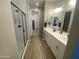 Elegant bathroom featuring a dual sink vanity, a walk-in shower, and modern fixtures and hardware at 25657 N 185Th Dr, Surprise, AZ 85387