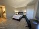 Tranquil bedroom with soft carpet, a comfortable bed, and an ensuite bathroom for added privacy at 25657 N 185Th Dr, Surprise, AZ 85387