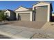 Charming single-story home with a well-manicured yard, a two-car garage, and stone accents in the driveway at 25657 N 185Th Dr, Surprise, AZ 85387
